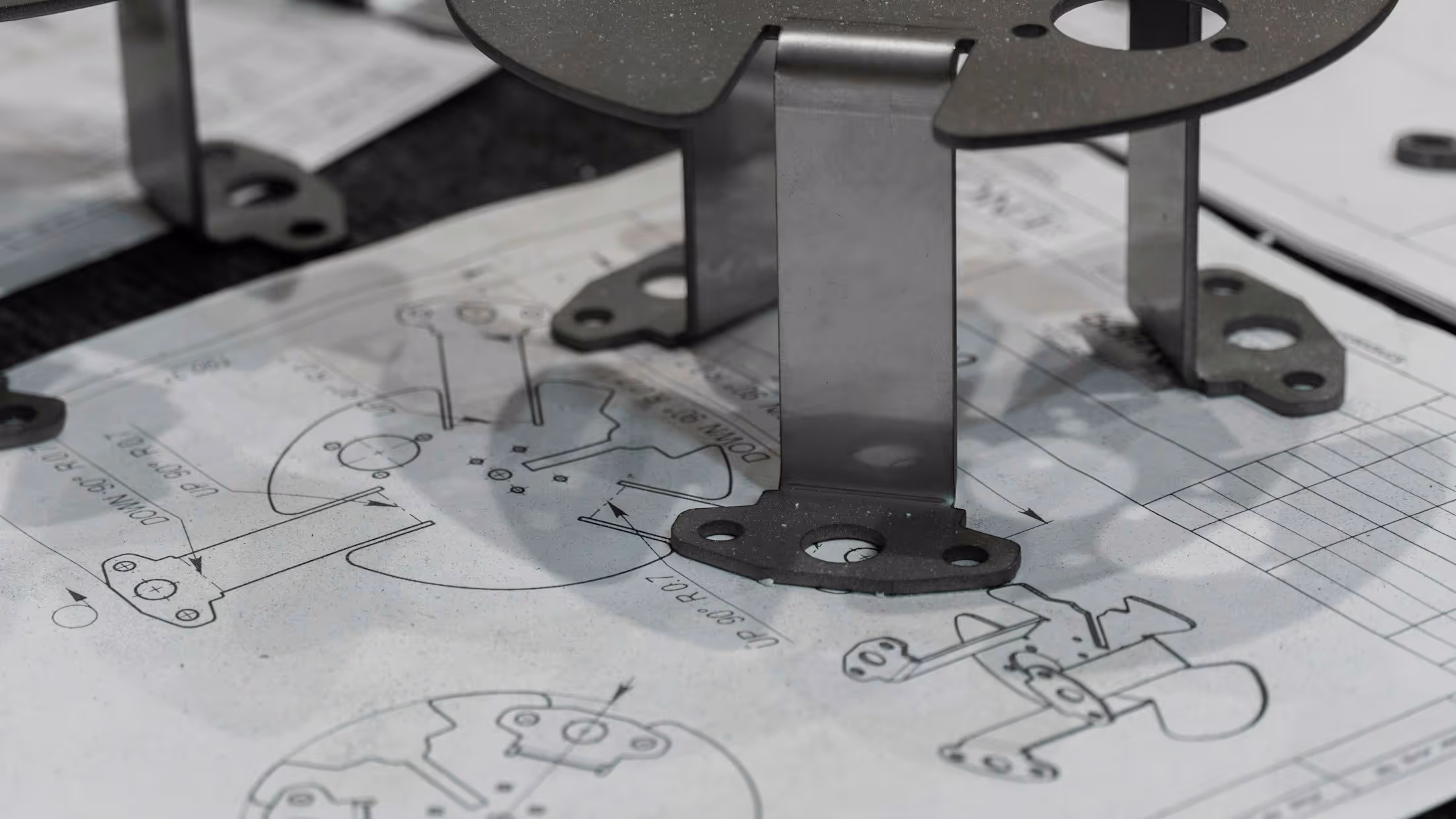 Metal components positioned on printed engineering drawings