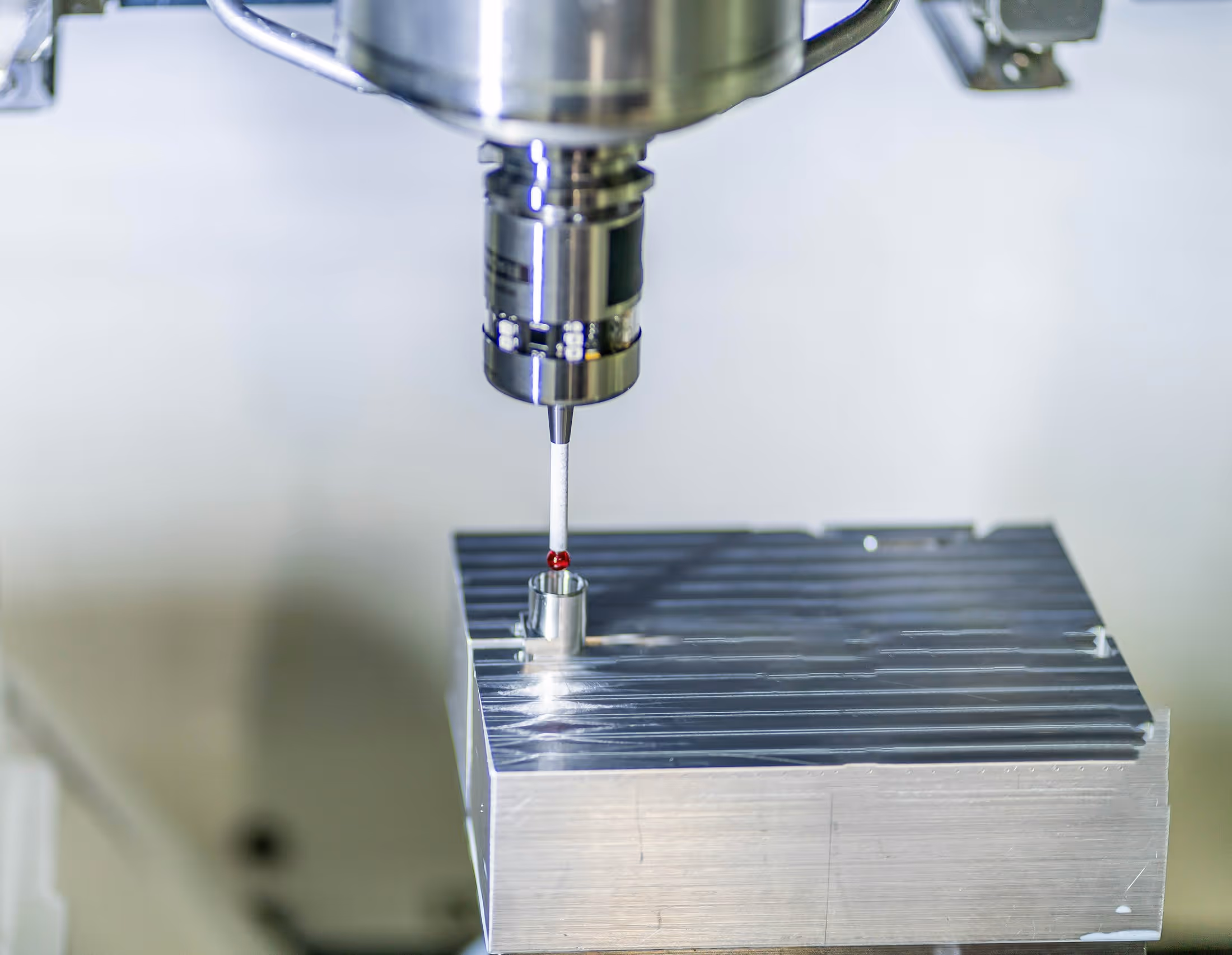 Touch probe checking a machined metal block