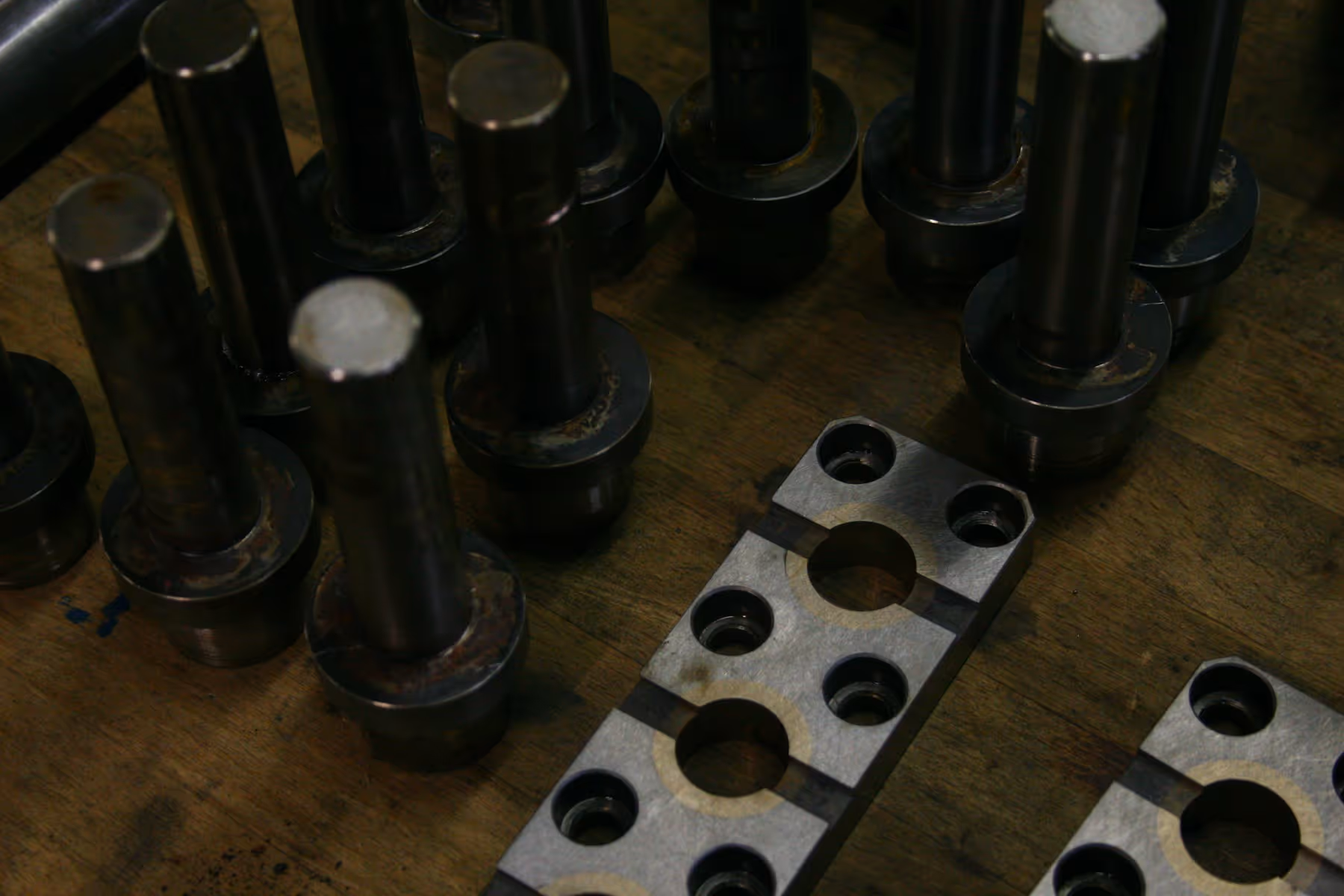 Assorted metal components arranged on a workshop surface